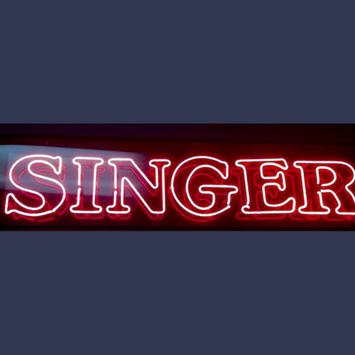 Vintage Singer sewing machine advertising neon sign