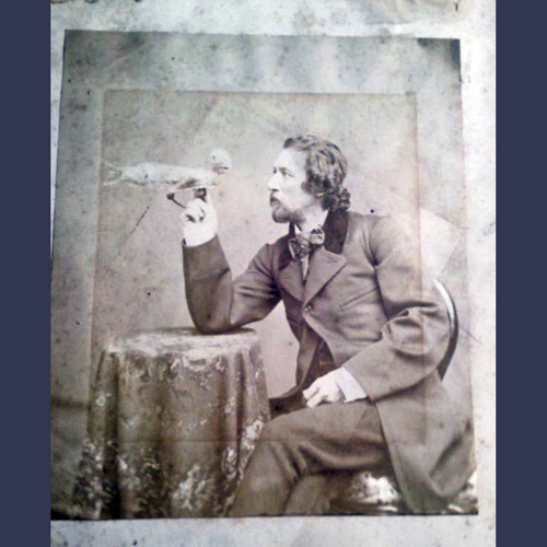 Antique cabinet photo of a magician with his Figi mermaid